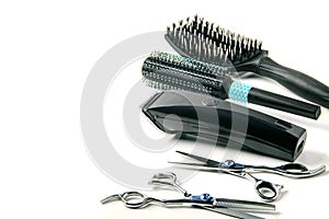 Scissors, hair clipper and combs on white background.