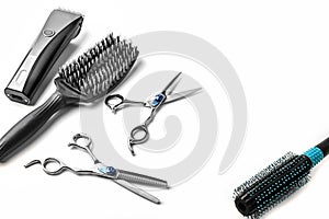 Scissors, hair clipper and combs on white background.