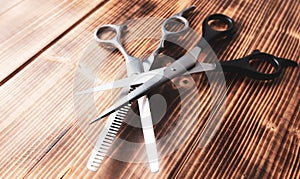 Scissors for haircuts on a wooden background