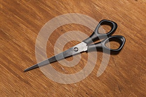 Scissors of a hairdresser on a wooden surface