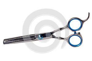 Scissors isolated. Close-up of a new professional thinning scissors for haircuts isolated on a white background. Barbers or