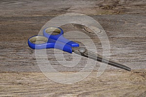 Scissors isolated on wooden background - close-up