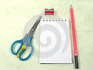Scissors, notebook, pencil and pencil sharpeners
