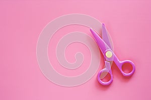 Scissors on pink background