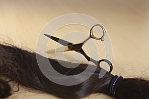 Scissors placed on a wooden table surface