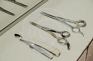 Scissors and razor blades on white table