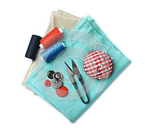 Scissors, spools of threads and sewing tools on white background, top view