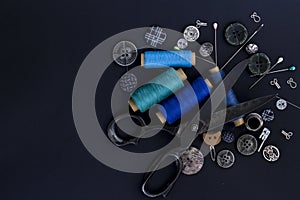 Scissors, thread and buttons. Tailoring tools and accessories on