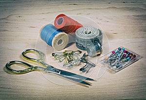 Scissors, thread, pins. Photo in old image style