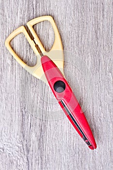 Scissors on wooden background.