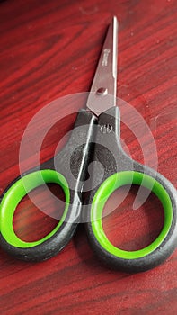 scissors on a wooden background, close-up, top view. multipurpose scissors