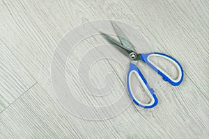 Scissors on a wooden background. Open and sharp. Top view. Copy space.