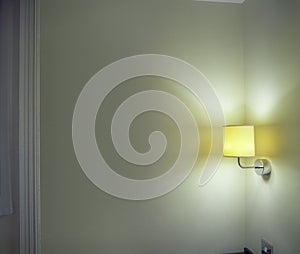 Sconce Shining Light On Wall In Room