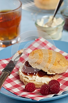 Scone with clotted cream and jam photo