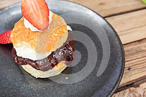 Scone with cream and strawberry jam