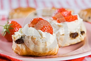 Scones, strawberries and clotted cream photo