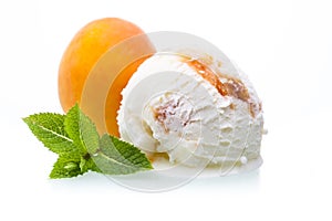 A scoop of apricot ice cream in front of an apricot