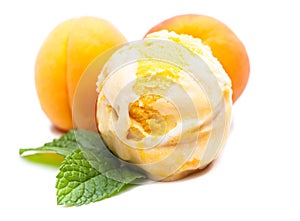 A scoop of apricot ice cream with mint and real apricots