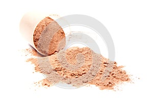 A scoop of chocolate whey isolate proteinon white photo