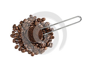 Scoop with coffee grounds and roasted beans on white background