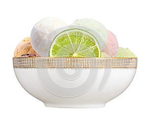 Scoop of fruit ice cream with lime slice in plate isolated