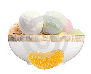 Scoop of fruit ice cream and orange slice in plate isolated on w