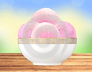 Scoop of fruit ice cream in plate on bright nature