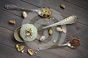 Scoop of homemade pistachio ice cream with chopped pistachios and chocolate