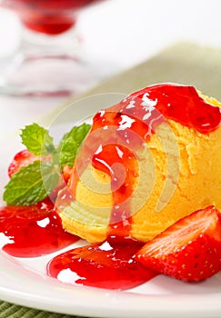 Scoop of ice cream with strawberry sauce
