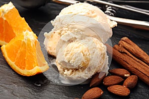 scoop of orange ice cream with almond and chocolate