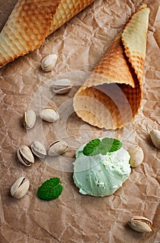 Scoop of pistachio ice cream and waffle cone