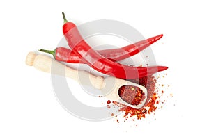 Scoop with spice and chilli peppers isolated on background