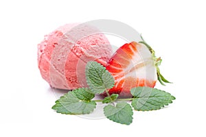 A scoop of stawberry ice cream decorated with mint leaves and strawberries