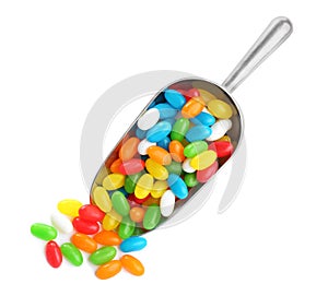 Scoop of tasty jelly beans on white background