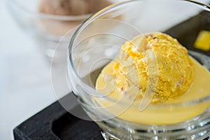 Scoop of yellow ice cream in a bowl