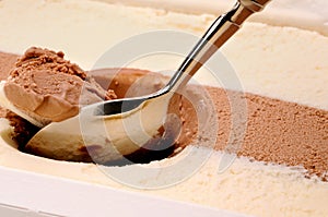 Scooping chocolate and vanilla ice cream