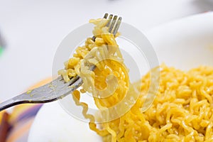 Scooping the noodles using fork instead of chopstick