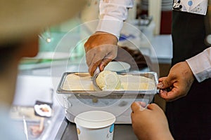 Scooping Vanilla Ice Cream From Bucket