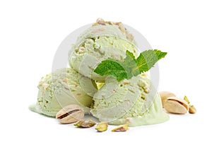 Scoops of delicious pistachio ice cream with mint and nuts on white