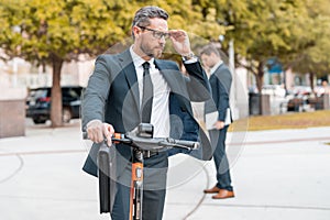 Scooter allows business man in suit to be efficient and punctual. Electric scooter provides a quick and easy for