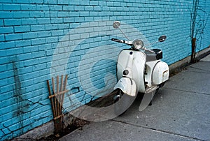 Scooter on a blue wall.