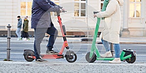 Scooter in the city. Couple meeting using ecological transport in street.