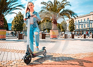 Scooter girl. Kick electric city bike using from business woman. Modern and ecological transportation concept.