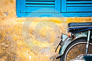 Scooter parked at old building in Vietnam, Asia.