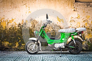 Scooter parked at old building in Vietnam, Asia.