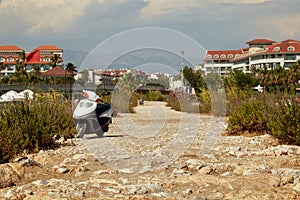 Scooter on rocky road in turkey on the shores of the mediterranean sea