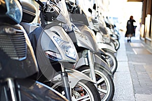 Scooters on city street and woman