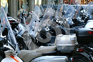 Scooters and mopeds with winter windshield parked in the city