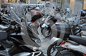 Scooters and motorcycles with windshields in winter parked
