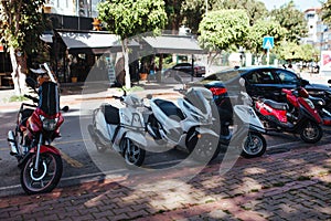 scooters parked to the sidewalk on the streets